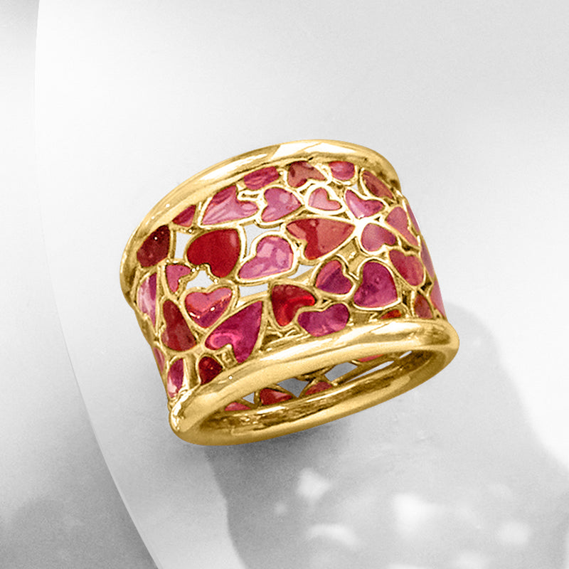 Gold enamel heart ring with red and pink heart motif, top view on stand