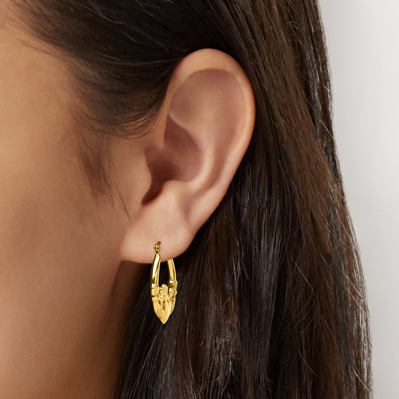 10kt yellow gold claddagh hoop earrings on ear, heart and crown detail