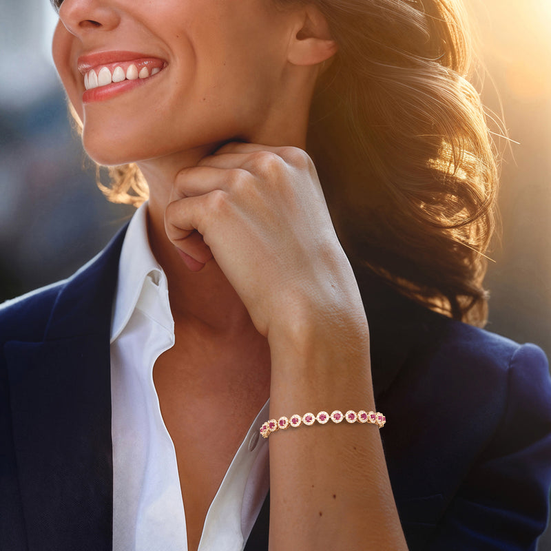 Ruby and diamond tennis bracelet on wrist in 14kt yellow gold