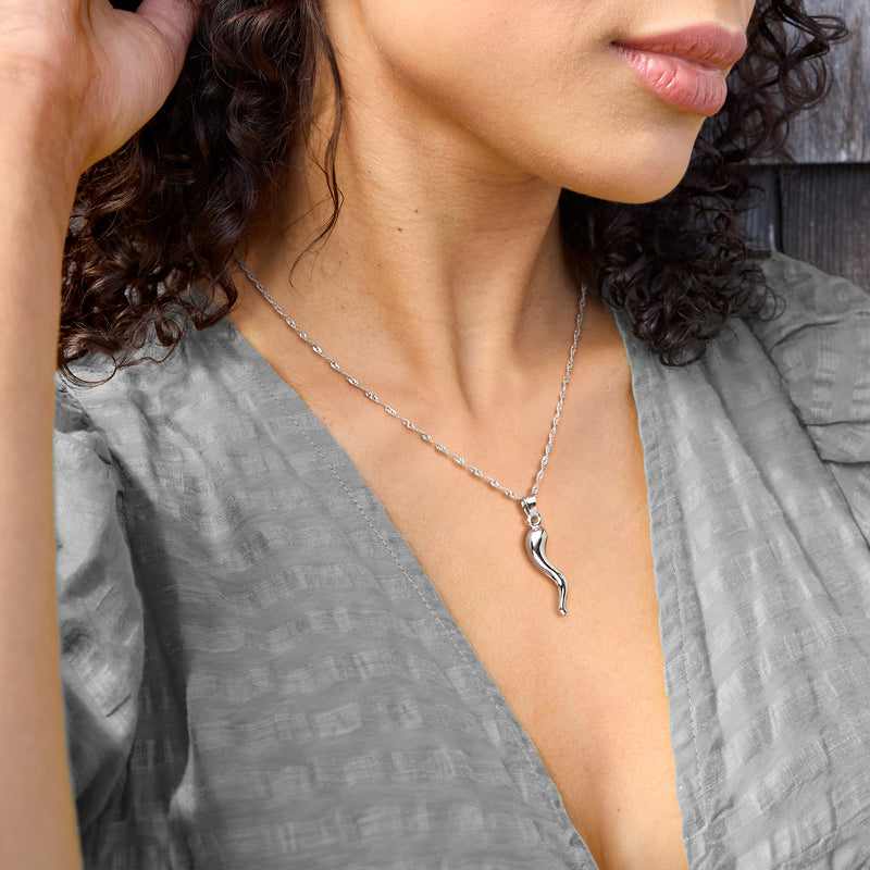 Horn pendant necklace in sterling silver on a chain, worn on the neckline