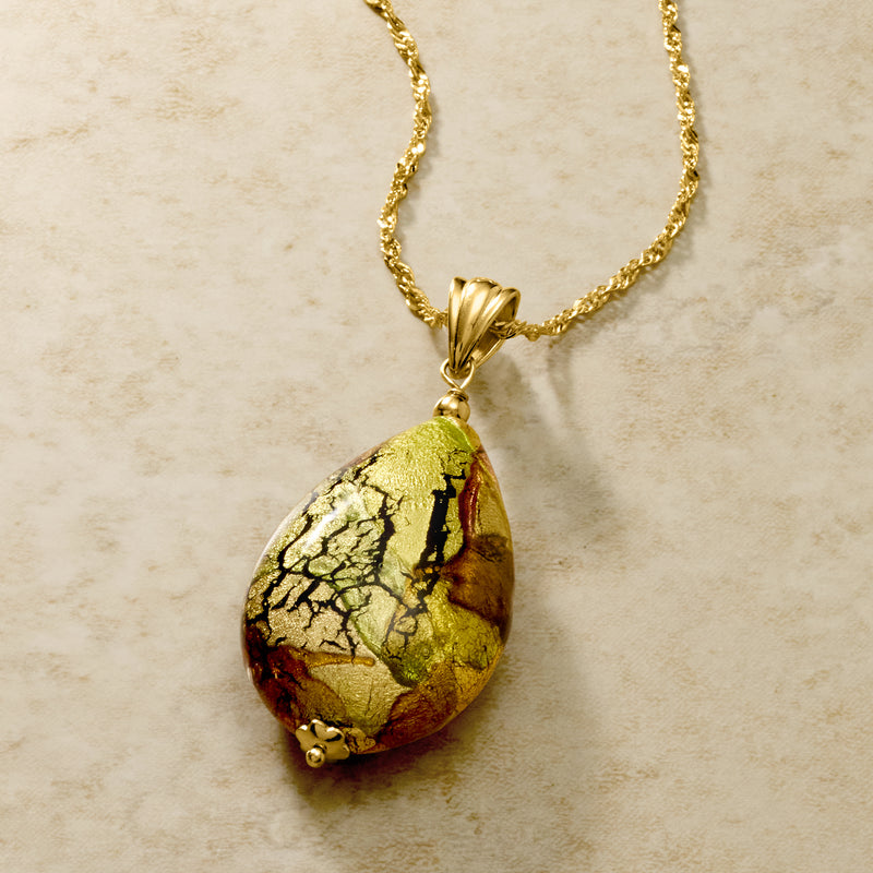 Close-up gold necklace chain with teardrop multicolored Murano glass pendant