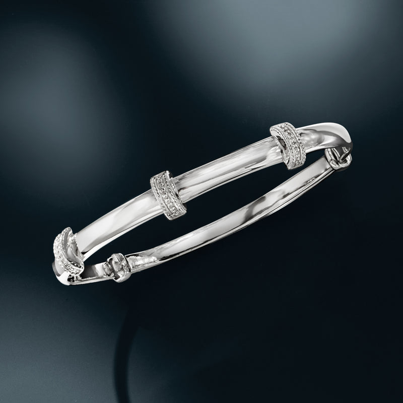 Sterling silver bangle bracelet with textured diamond-like pave stations and clasp