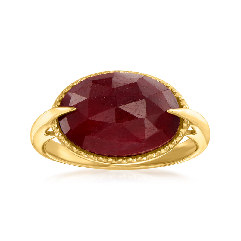 Oval ruby gemstone ring with bezel and gold band, halo of small stones
