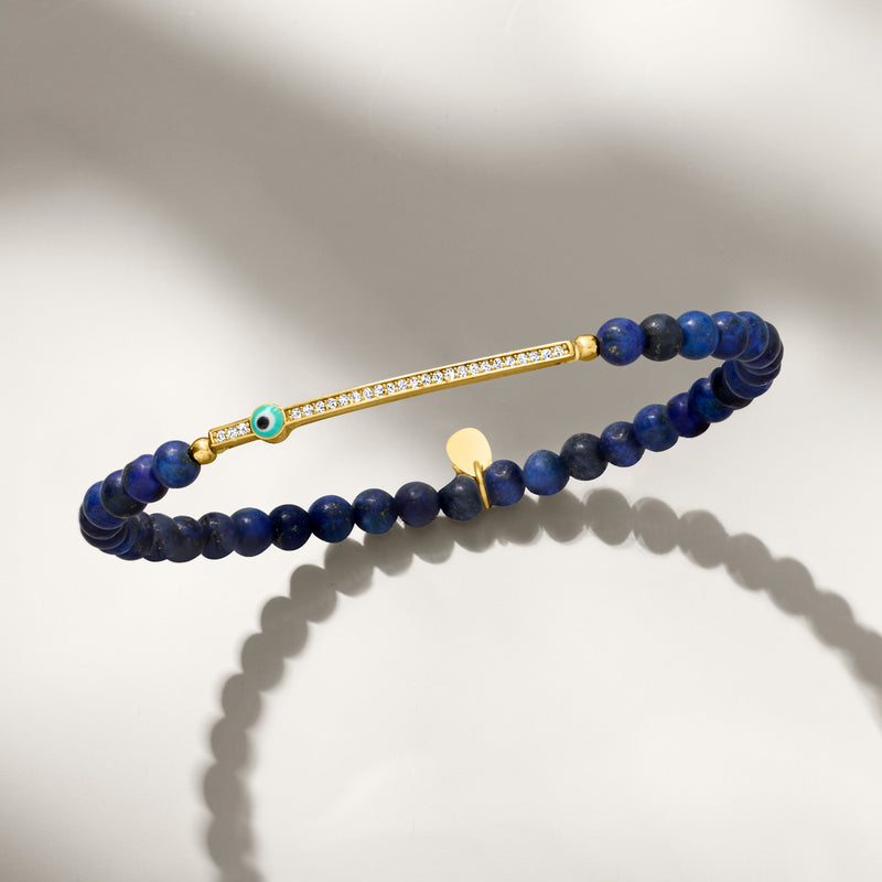 Lapis evil-eye CZ stretch bracelet with gold bar and round blue eye bead charm