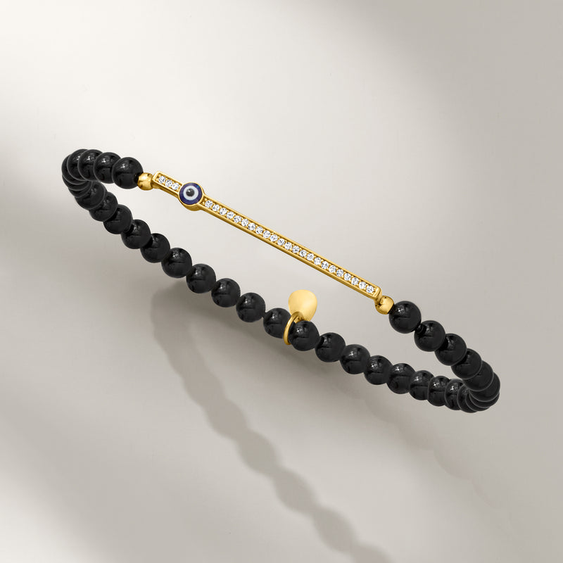 Black onyx bead stretch bracelet with gold evil eye bar and CZ accents