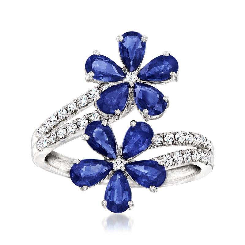 14kt white gold bypass ring with blue sapphire flower clusters and diamond accents