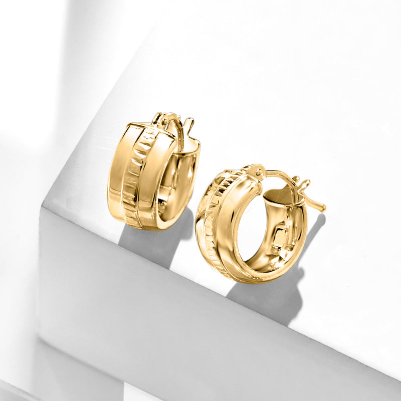 Yellow gold huggie hoops with ridged front band and hinged closure, side view