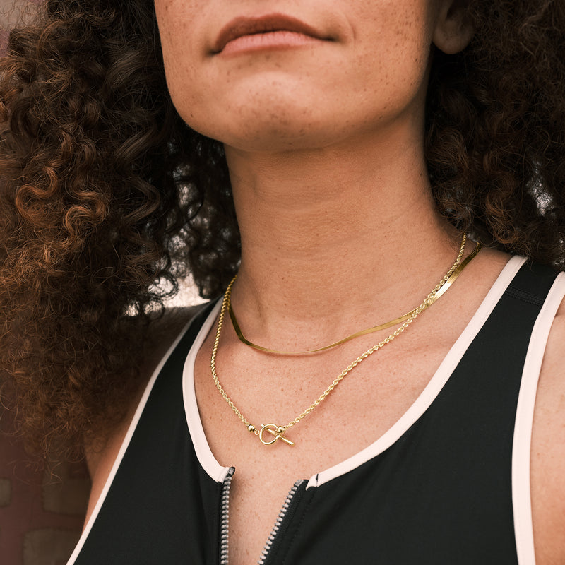 Rope-chain toggle necklace in 10kt yellow gold at collar with heart bar clasp