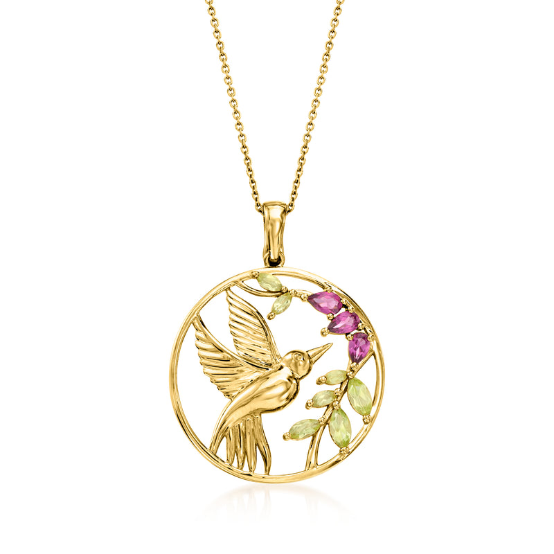 Gold hummingbird pendant necklace with peridot and rhodolite gemstones in a round frame