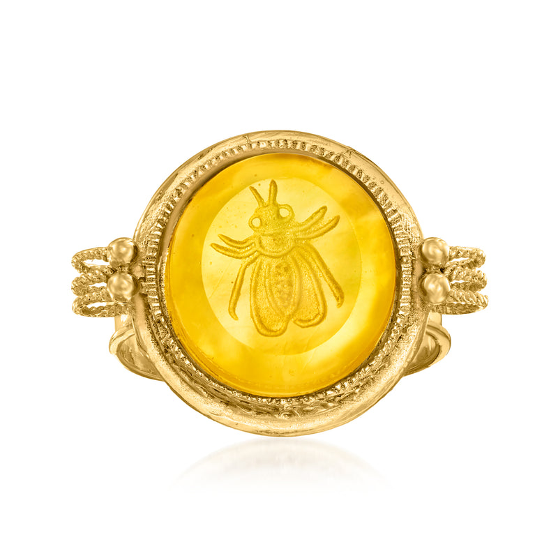 Oval yellow glass doublet ring with engraved bee motif, gold bezel and twisted band