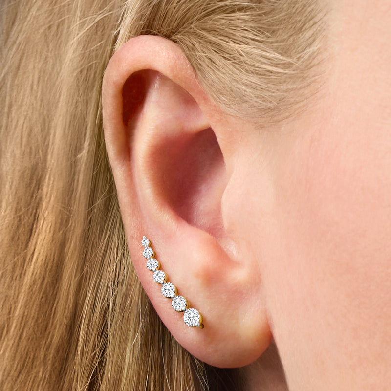 Diamond earwire climber earrings on ear, five round stones in 14kt yellow gold