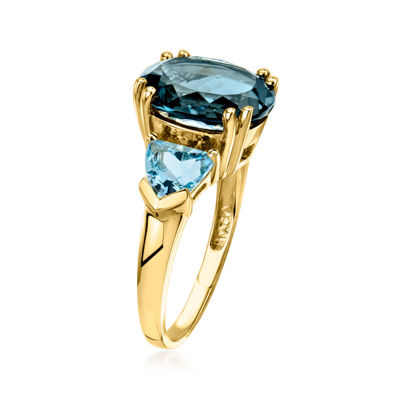 14kt yellow gold three-stone ring with oval blue topaz center and light-blue side stones