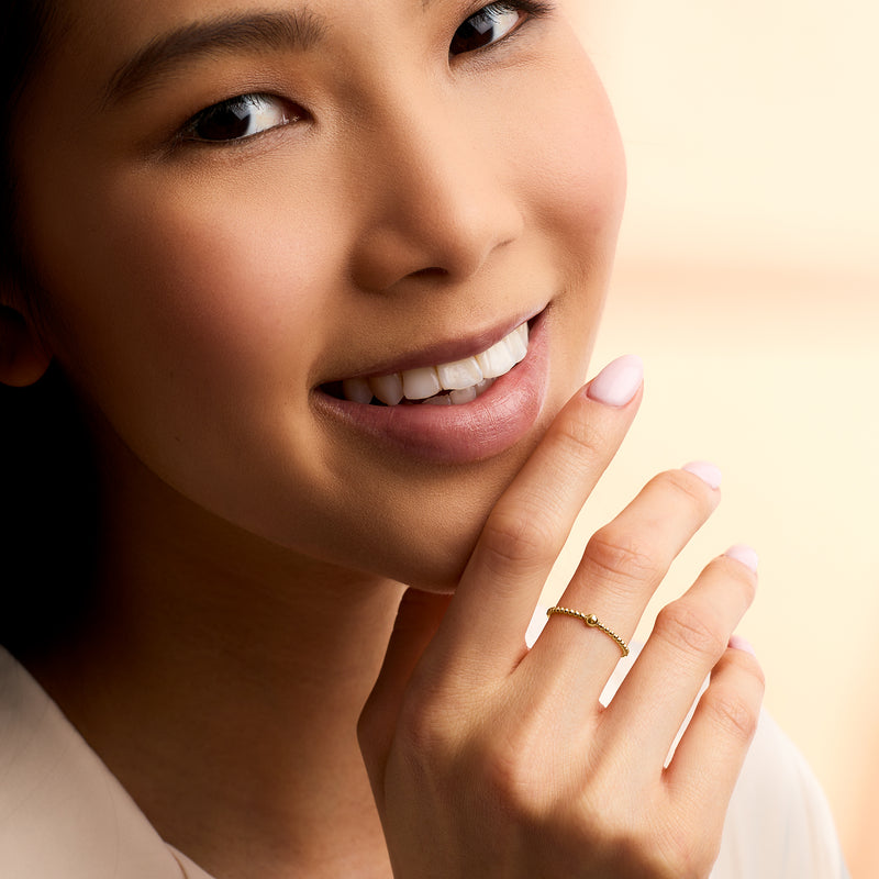 14kt yellow gold beaded ring with ball detail on finger