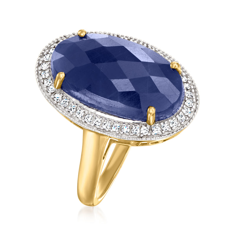 Oval blue sapphire ring with diamond halo and gold prongs, angled side view