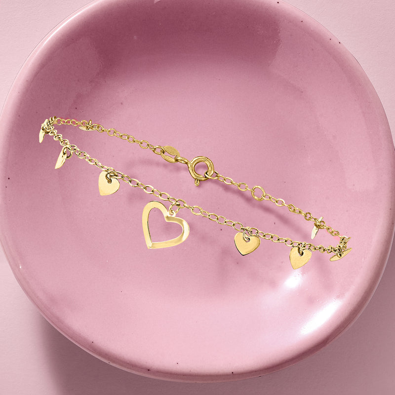 Yellow gold heart station bracelet, oval clasp and dangling heart charms in a row