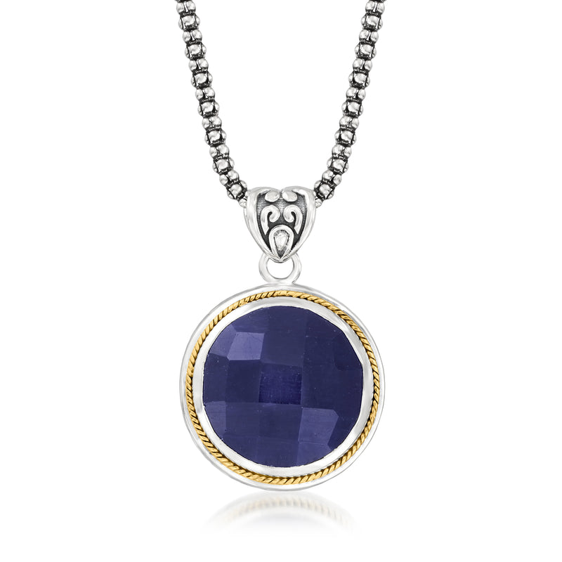 Sapphire pendant necklace with round dark blue stone, yellow gold rim and silver chain