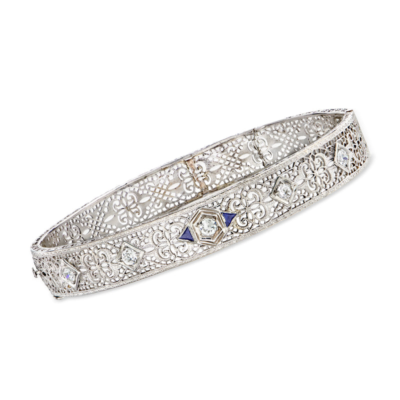 Vintage white gold filigree bangle bracelet with blue sapphire and diamond accents