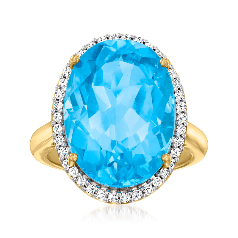Oval Swiss blue topaz ring in 18kt gold over sterling with diamond halo