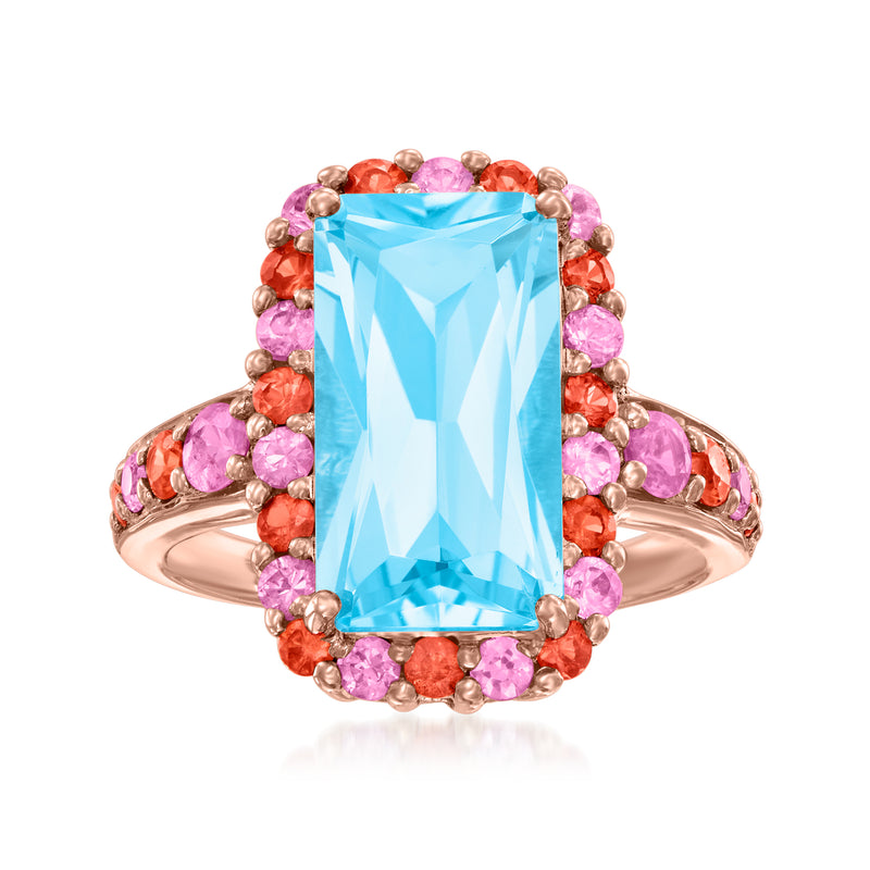 Rose gold ring with large sky-blue topaz centerpiece and pink/orange sapphire halo