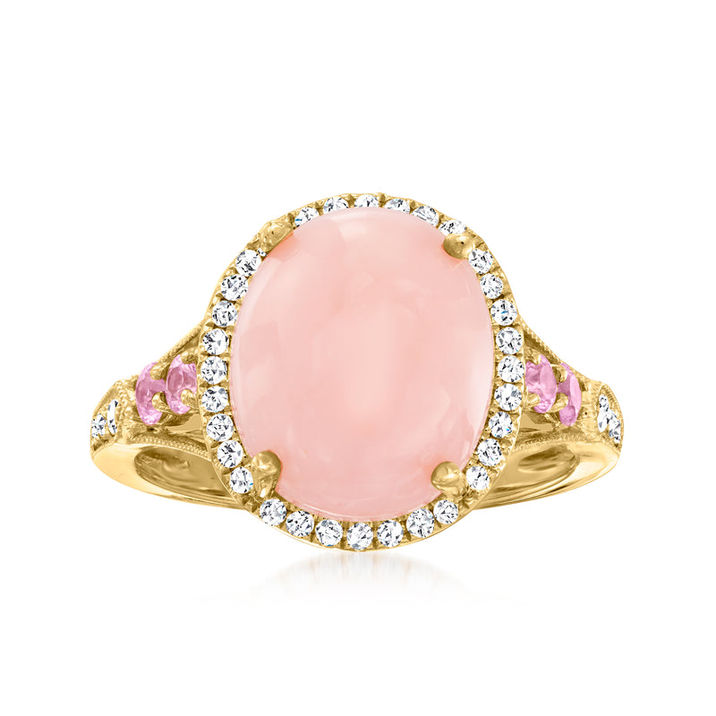 14kt yellow gold ring with oval pink sapphire center, diamond halo, and pink side stones