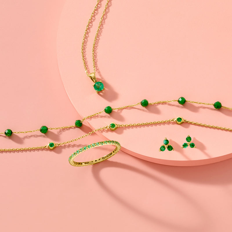 Gold chain necklace with small round green emerald pendant and clasp