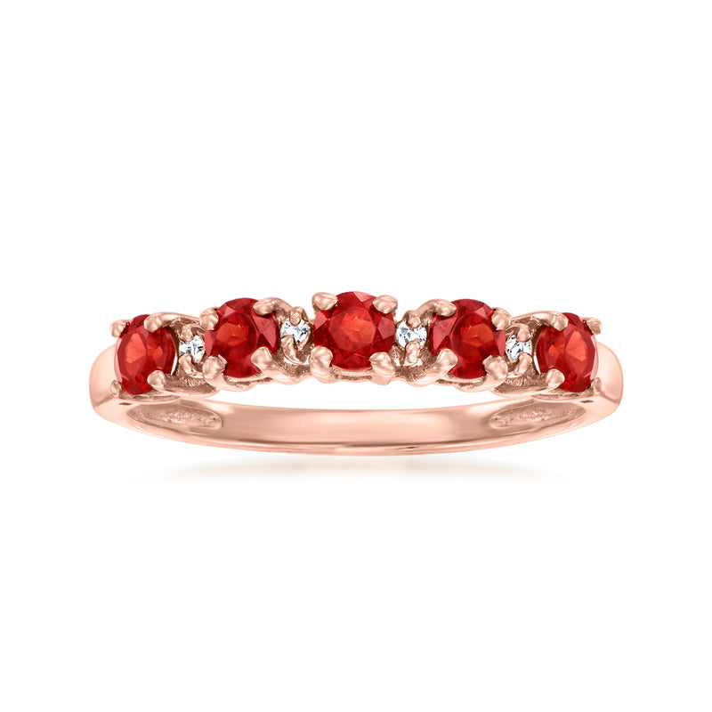Rose gold ring with red garnet gemstones and diamond accents