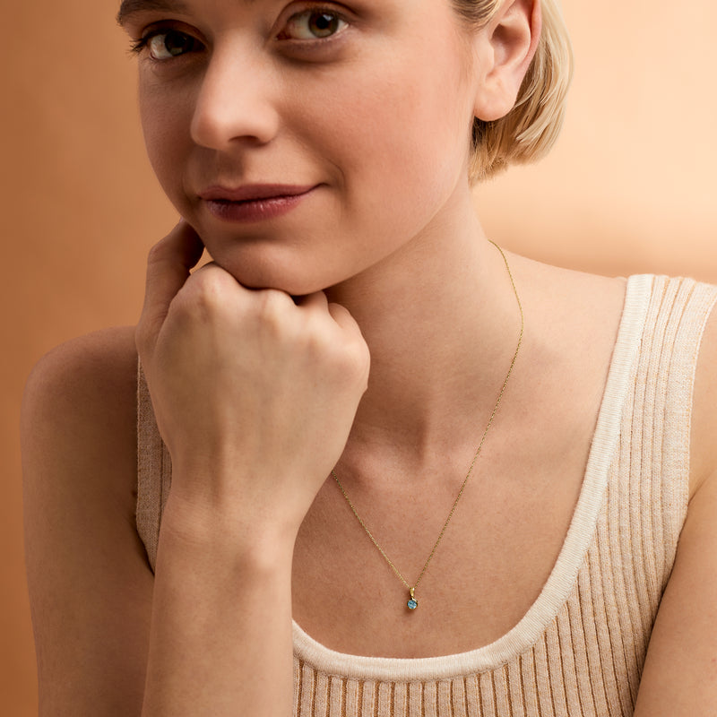 14kt yellow gold pendant necklace with round blue topaz gemstone on thin chain