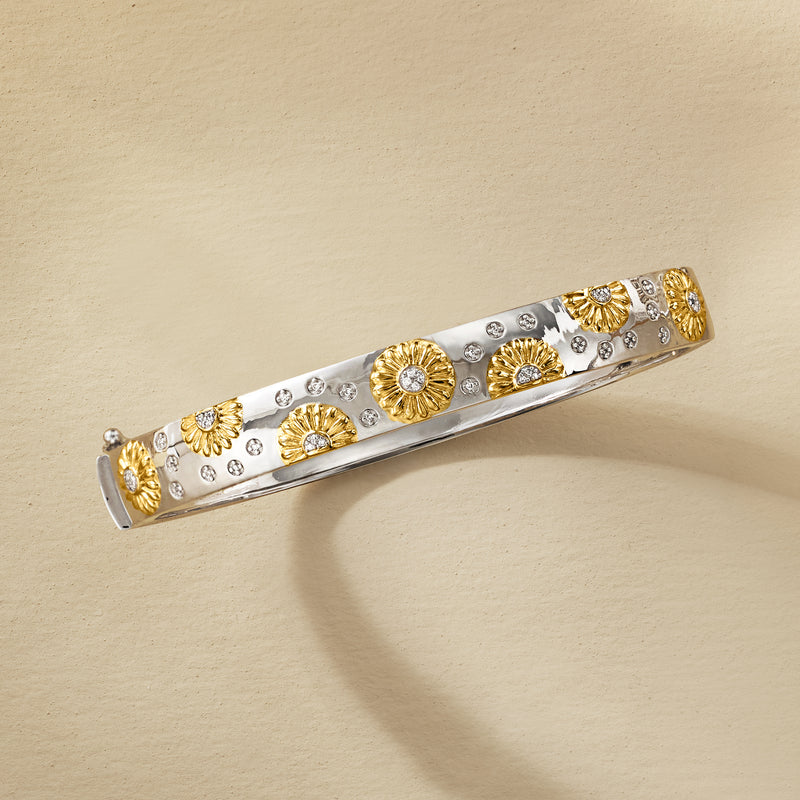 Two-tone sterling silver bangle, angled, with gold sunflower motifs and clear stone accents