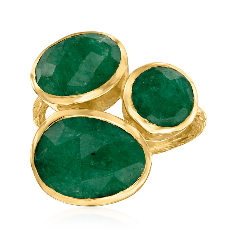 Three-stone emerald ring with oval green gemstones in gold bezel settings