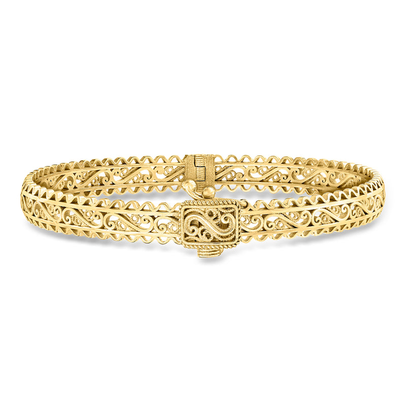 Gold-tone filigree bangle bracelet with hinged centerpiece and decorative latch