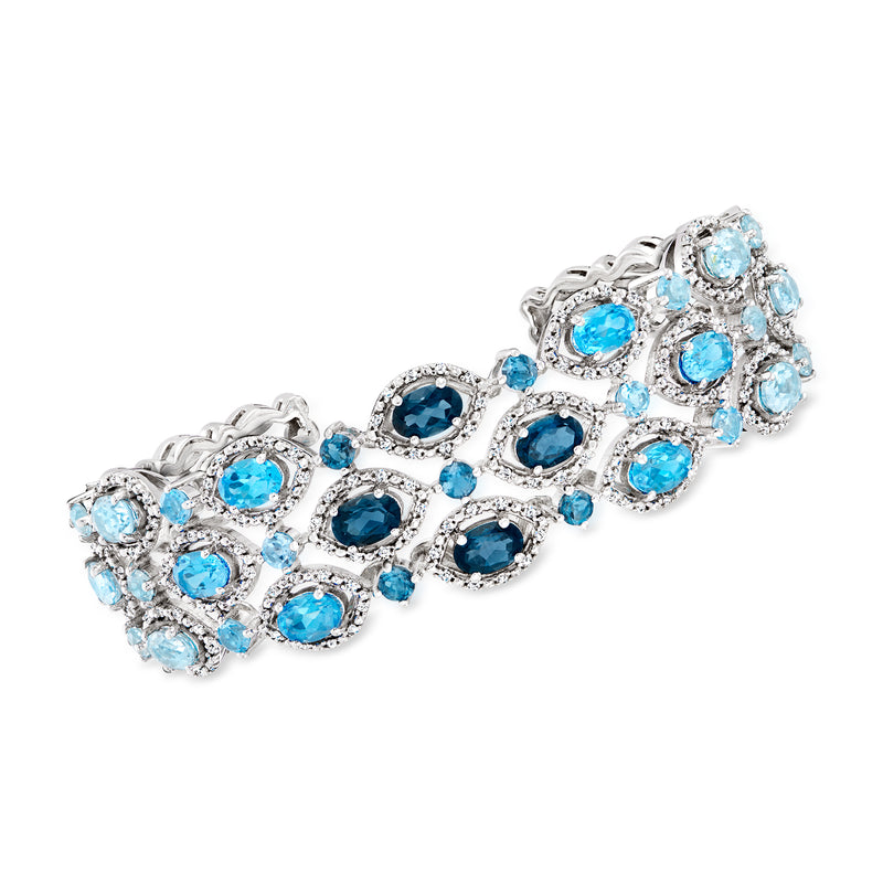 Sterling silver cuff bracelet with oval blue gemstones and clear zircon accents.