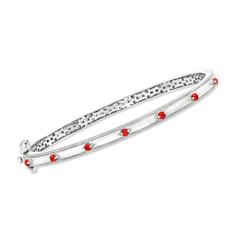 Sterling silver garnet bangle bracelet with textured bar and five red gemstones