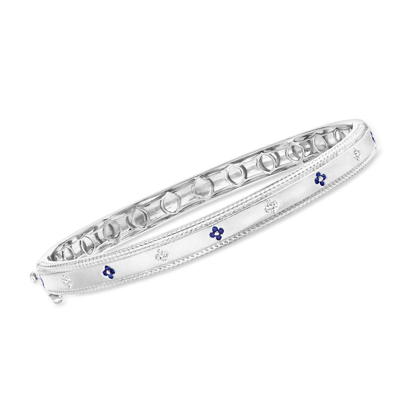 Sterling silver bangle bracelet with sapphire flower accents and diamond-like detailing