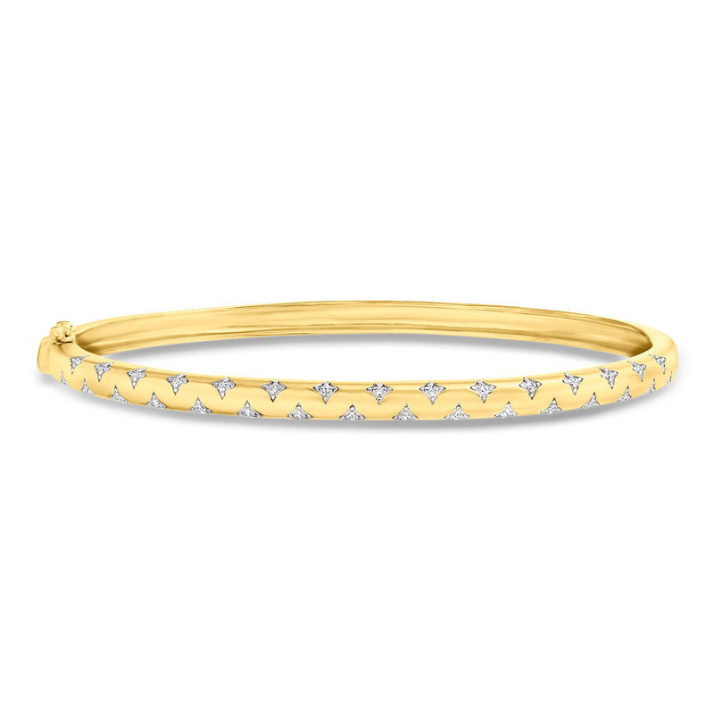 Gold bangle bracelet with star-shaped gemstone pattern along the front