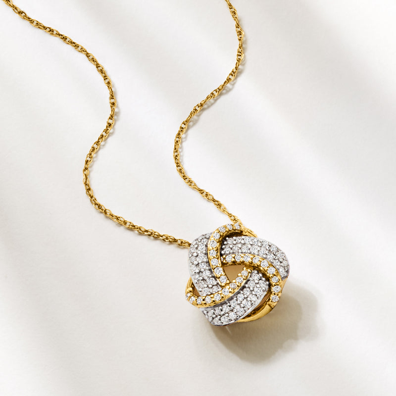 Love knot diamond pendant necklace in 10kt yellow gold, angled view