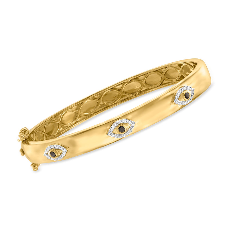 Gold-tone evil eye bangle bracelet with textured oval links and blue-and-clear stone accents