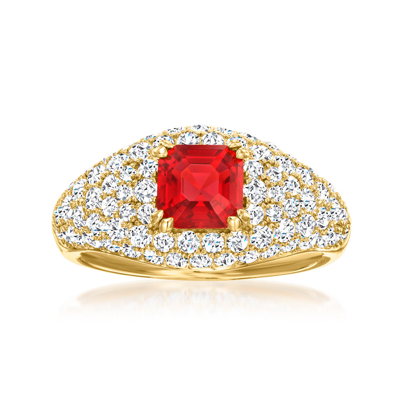 Gold-tone ring with red emerald-cut simulated ruby center and CZ halo