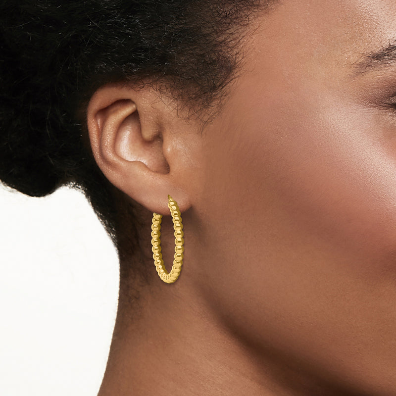 18kt yellow gold beaded hoop earrings on ear, close-up 30mm hoops