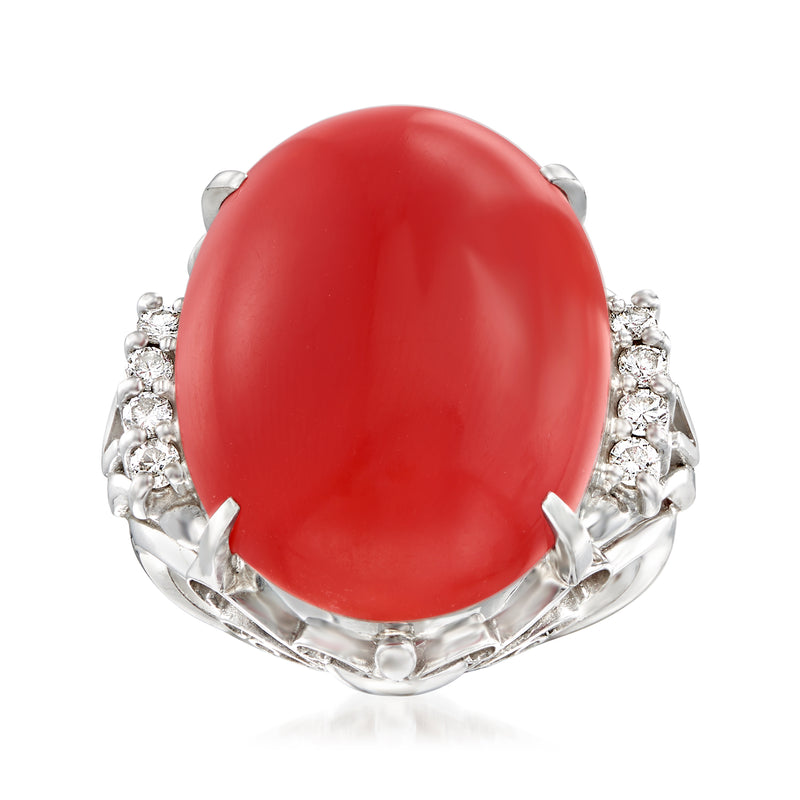 Platinum ring with red coral oval cabochon and diamond clustered shoulders