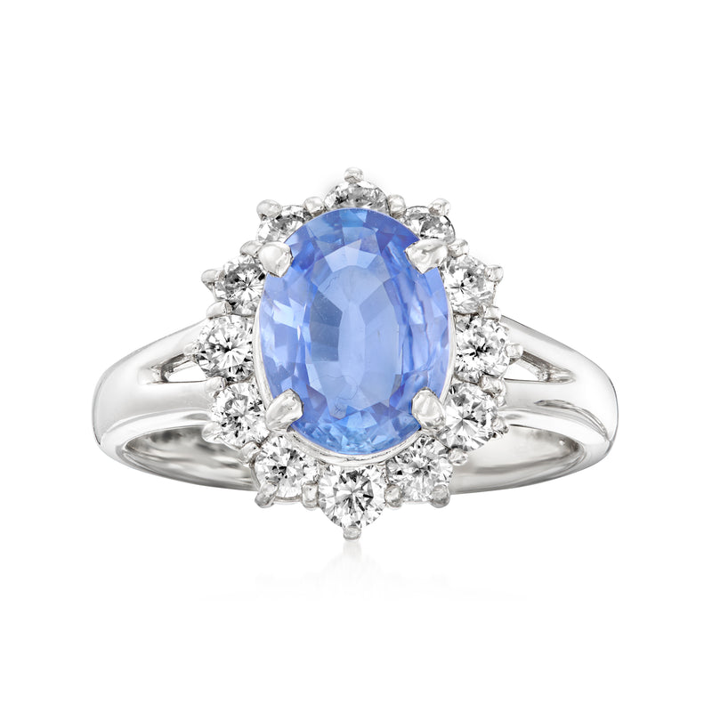 Platinum dinner ring with oval blue sapphire and surrounding round diamonds