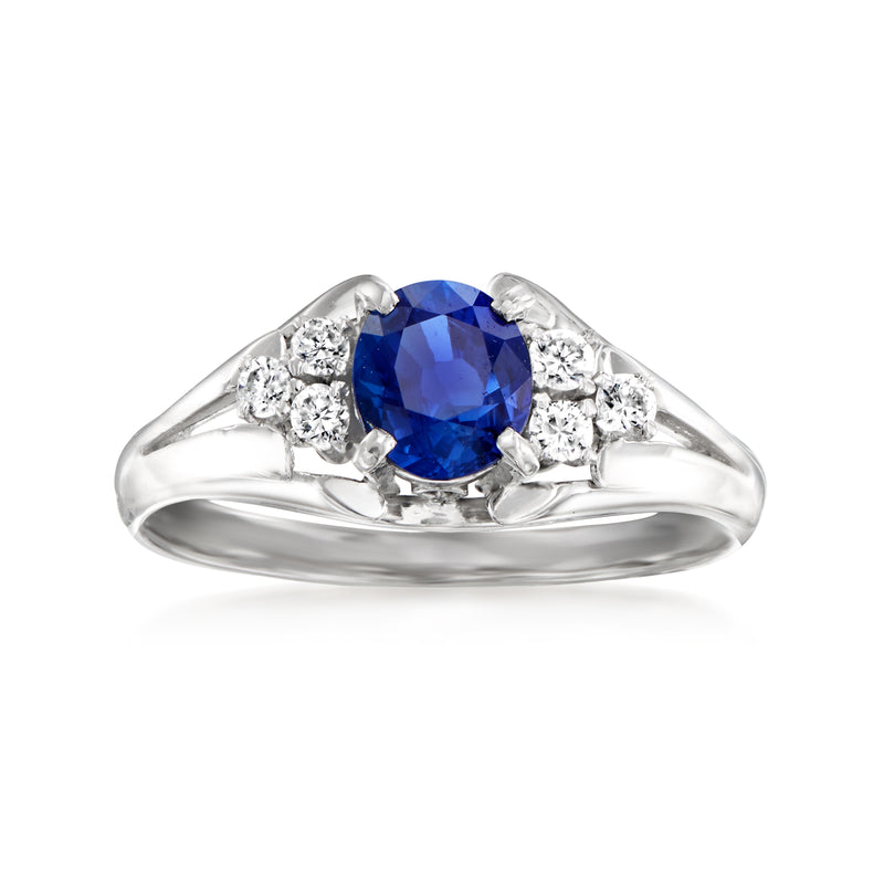Platinum ring with blue oval sapphire and round diamond side stones, vintage setting