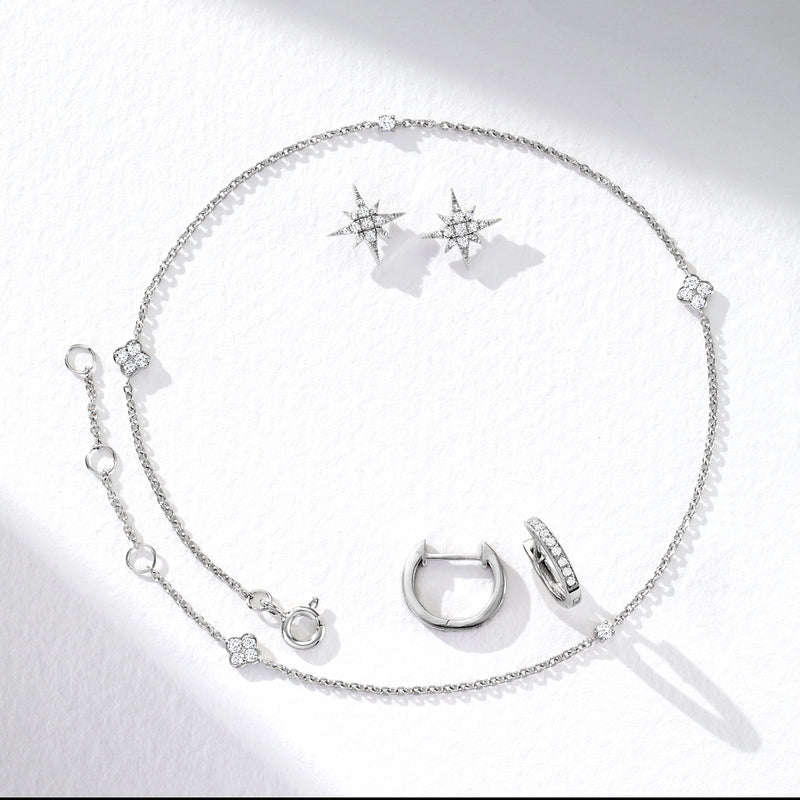 Sterling silver diamond anklet laid flat, showing stone stations and clasp hardware