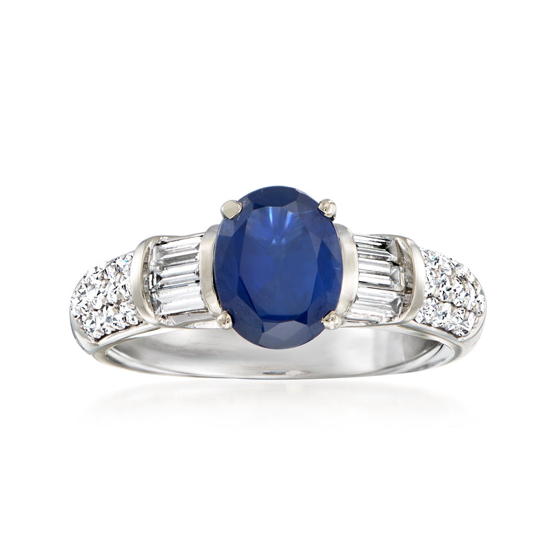 Vintage white-gold dinner ring with oval blue sapphire center and baguette diamond sides