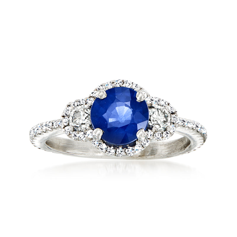 Platinum sapphire and diamond dinner ring with round blue center stone