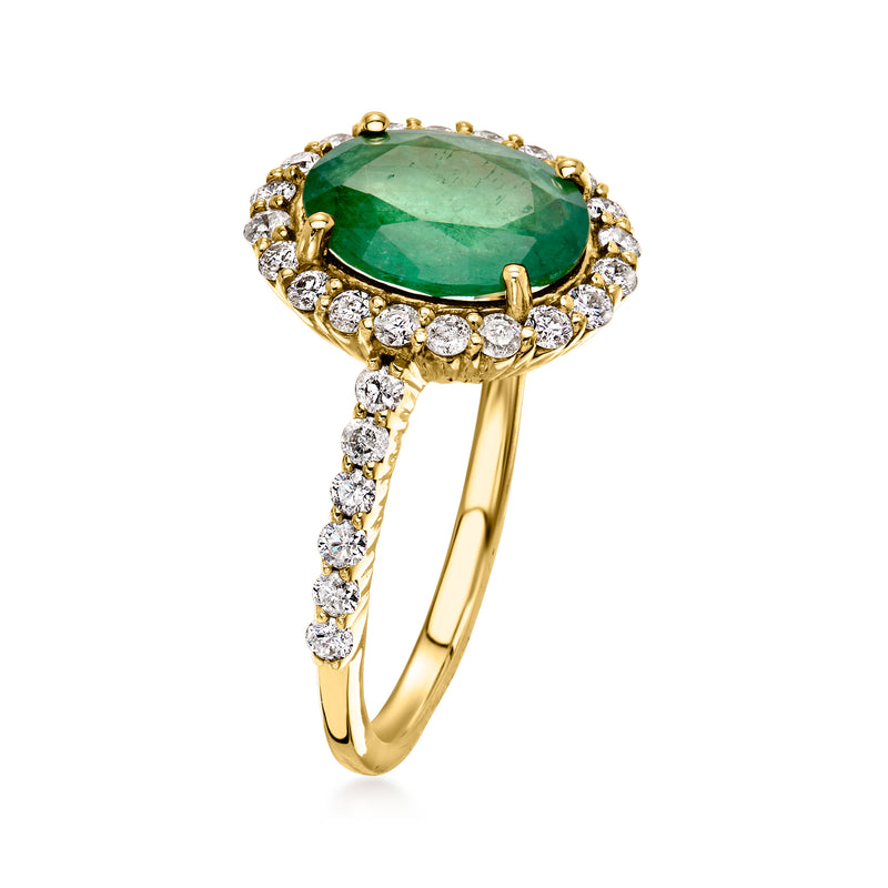Emerald-style green oval center with surrounding round diamonds on yellow gold ring