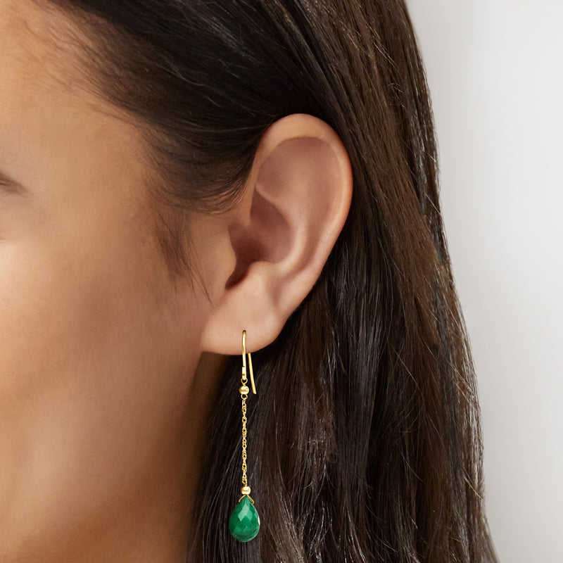 Close-up: green teardrop emerald earwire earrings in 10kt yellow gold