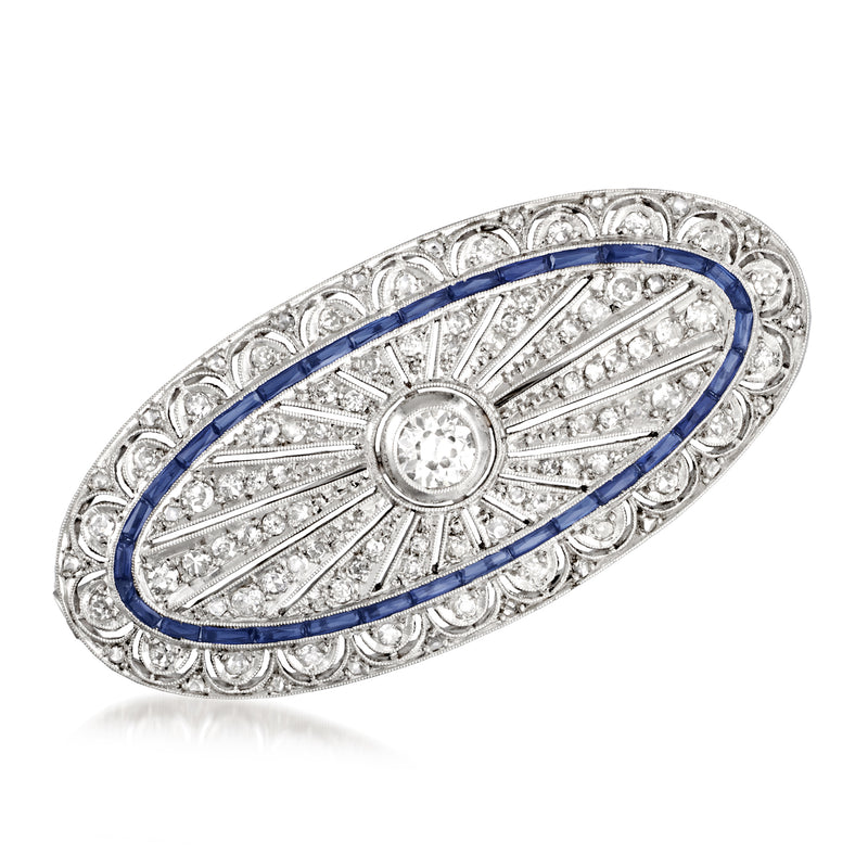 Vintage platinum filigree pin with oval blue sapphire border and round center diamond