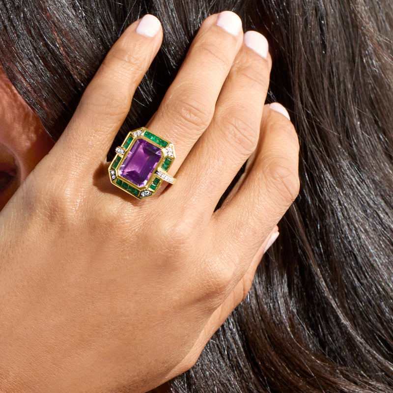 Amethyst and green stone ring in 14kt yellow gold with diamond accents, worn on hand