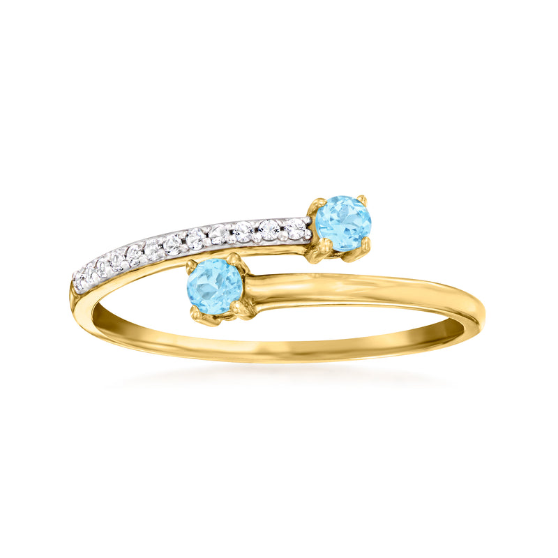 14kt yellow gold bypass ring with blue topaz stones and white diamond accents