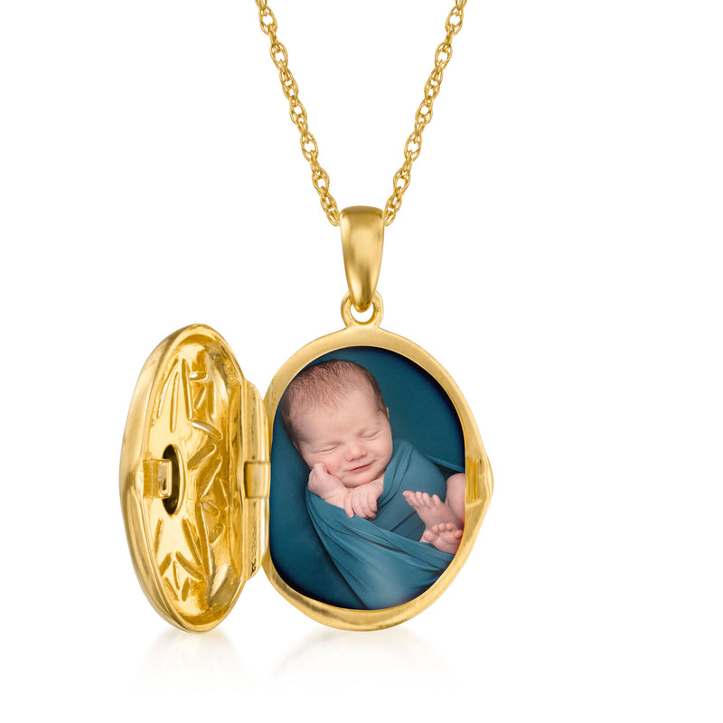 Gold locket necklace with oval pendant opened to show baby photo in blue frame